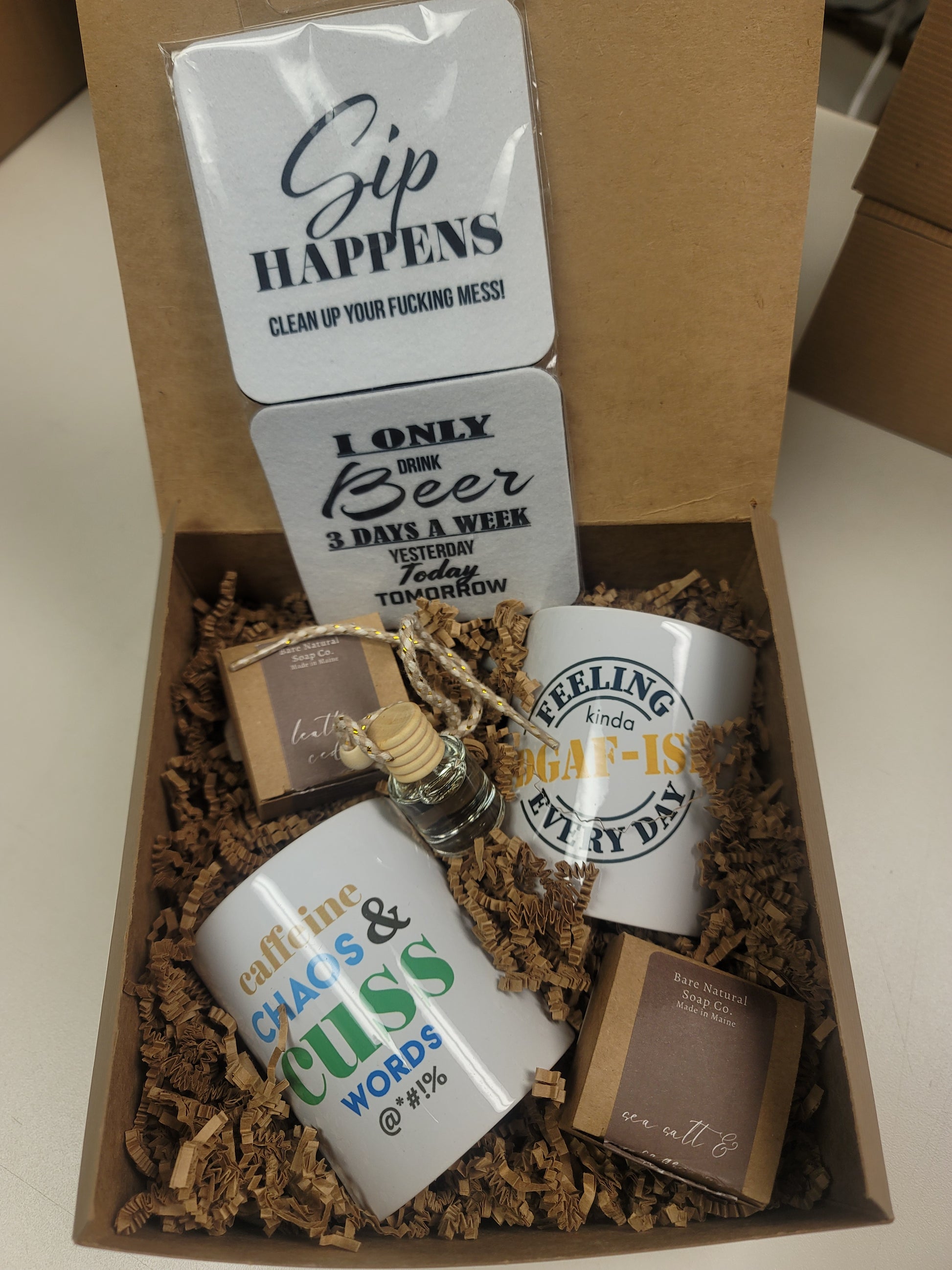 Gift set with mugs, coasters, and 2 car diffuser air fresheners in a gift box.