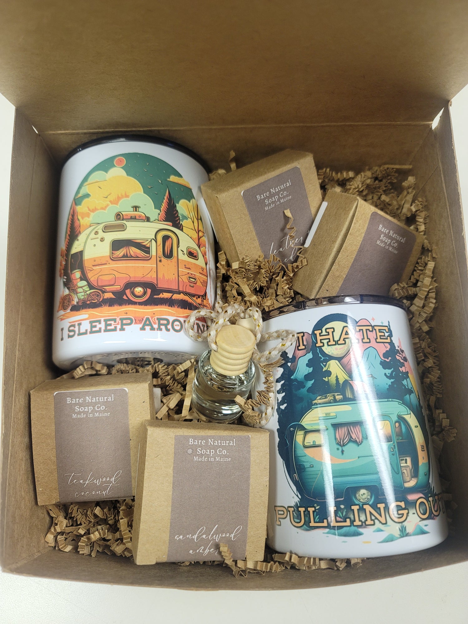 Two sublimated camper mugs with artistic designs and four car diffusers inside a box to enjoy the great outdoors.