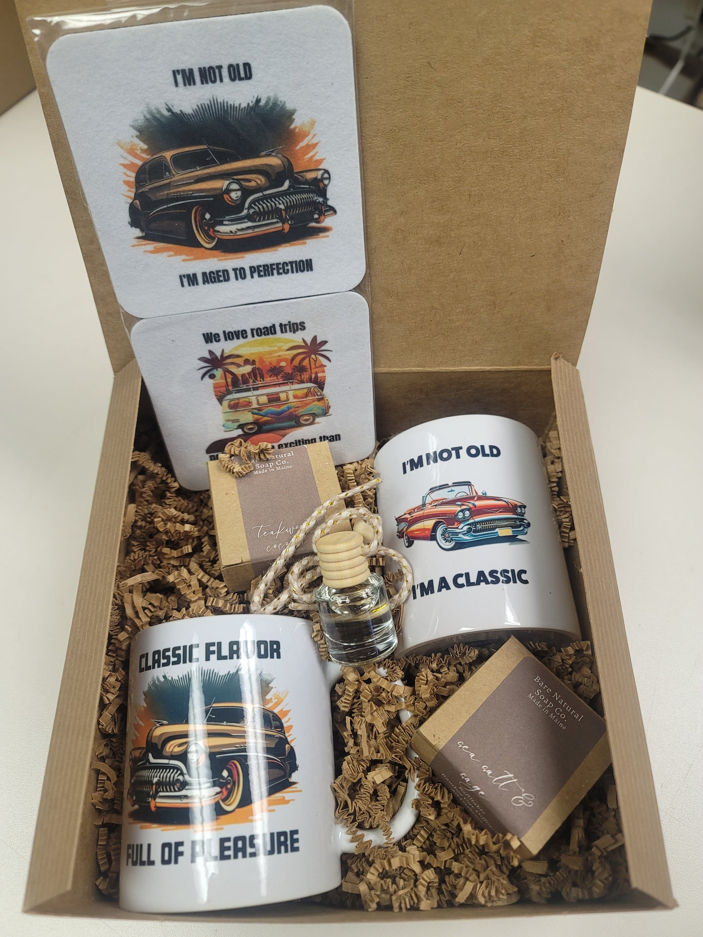 Gift set with mugs, coasters, and 2 car diffuser air fresheners in a gift box.